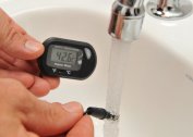What temperature should the water in the hot water supply system be?