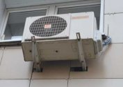 Installation of an external outdoor air conditioning unit in a wooden house