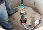 At what depth should the pump be immersed in a well?