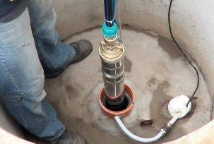 At what depth should the pump be immersed in a well?